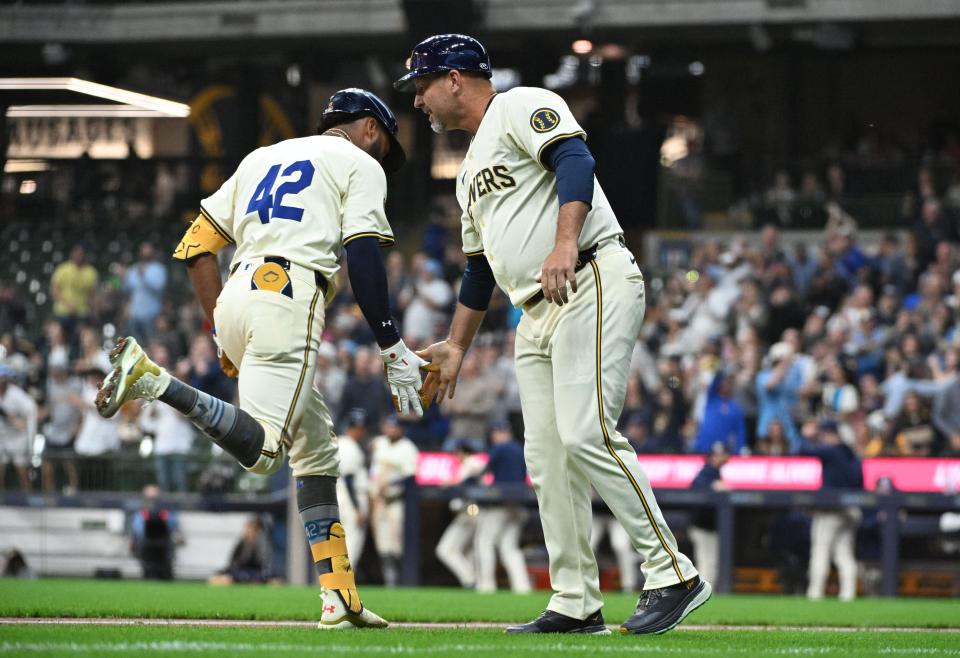 Brewers third base coach Jason Lane congratulates outfielder Jackson Chourio after his home run in the second inning.