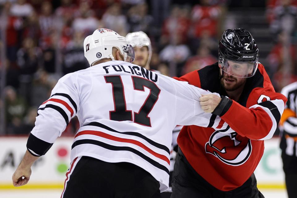 New Jersey Devils defenseman Brendan Smith (2) fights with Chicago Blackhawks left wing Nick Foligno during the second period of an NHL hockey game Friday, Jan. 5, 2024, in Newark, N.J. The Devils won 4-2. (AP Photo/Adam Hunger)