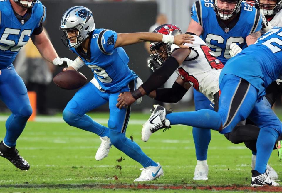 Dec 3, 2023; Tampa, Florida, USA; Carolina Panthers quarterback Bryce Young (9) runs past Tampa Bay Buccaneers linebacker Markees Watts (58) during the first half at Raymond James Stadium. Mandatory Credit: Kim Klement Neitzel-USA TODAY Sports