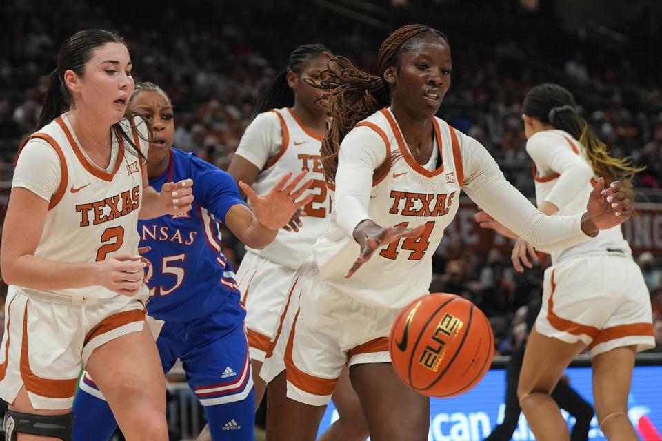 Texas forward Amina Muhammad, right, retrieves a rebound during the Longhorns' win over Kansas last Tuesday. The heralded freshman followed that game by playing 22 minutes in Sunday's 68-53 win over Iowa State.