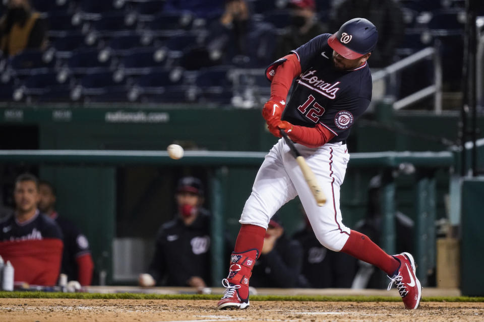 Washington Nationals' Kyle Schwarber hits a home run during the ninth inning of the team's baseball game against the Arizona Diamondbacks at Nationals Park, Friday, April 16, 2021, in Washington. The Nationals won 1-0. (AP Photo/Alex Brandon)