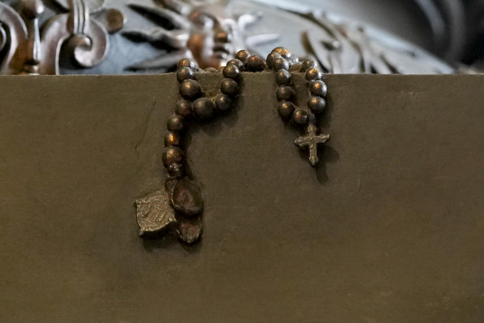 A detail showing a rosary at the base of the 17th century, 95ft-tall bronze canopy by Giovan Lorenzo Bernini surmounting the papal Altar of the Confession in St. Peter's Basilica at the Vatican, Wednesday, Jan. 10, 2024. Vatican officials unveiled plans Thursday, Jan.11, for a year-long, 700,000 euro restoration of the monumental baldacchino, or canopy, of St. Peter's Basilica, pledging to complete the first comprehensive work on Bernini's masterpiece in 250 years before Pope Francis' big 2025 Jubilee. (AP Photo/Andrew Medichini)