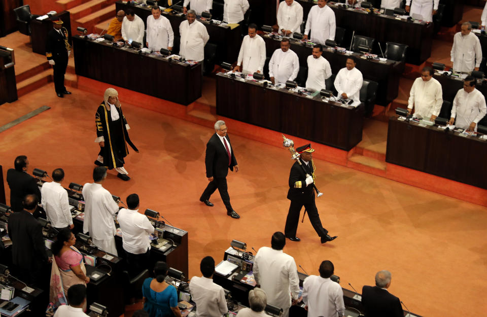 FILE- In this Jan. 3, 2020 file photo, Sri Lankan president Gotabaya Rajapaksa, center, along with speaker Karu Jayasuriya, center left, walk in the well of the house as he arrives to address the ceremonial inauguration of the session in Colombo, Sri Lanka. A proposed amendment to Sri Lanka’s constitution that will consolidate powers in the President’s hands has raised concerns about the independence of the country’s institutions and the impact on its ethnic minorities who fear their rights could be undermined by the majoritarian will. (AP Photo/Eranga Jayawardena, File)