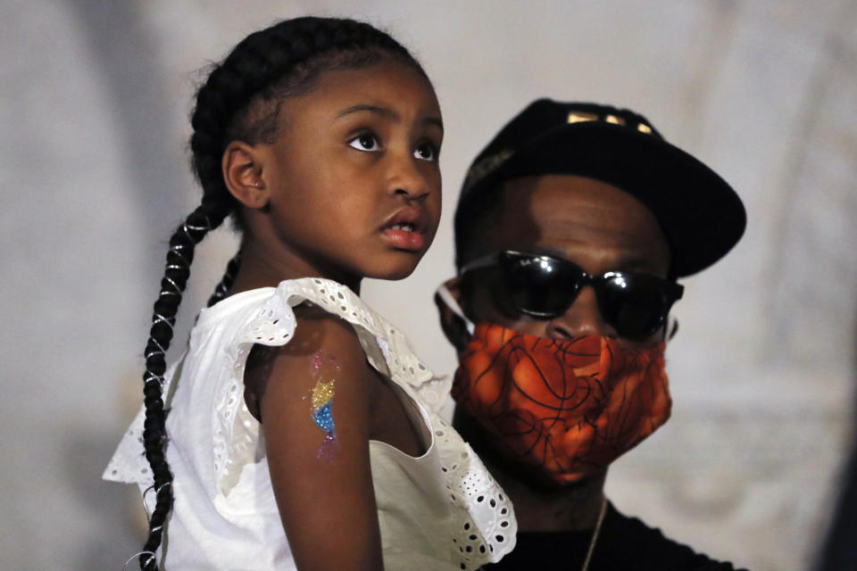Gianna Floyd, the daughter of George Floyd, listens to a a news conference with Stephen Jackson, Tuesday, June 2, 2020, in Minneapolis, Minn. The city has seen protests against police brutality sparked by the death of George Floyd, a black man who died after being restrained by Minneapolis police officers on May 25. (AP Photo/Julio Cortez)