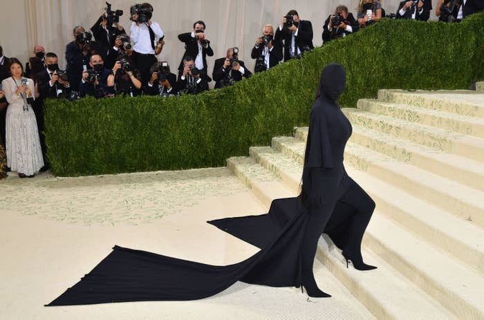 Kim's black ensemble, with long train, on the Met Gala steps