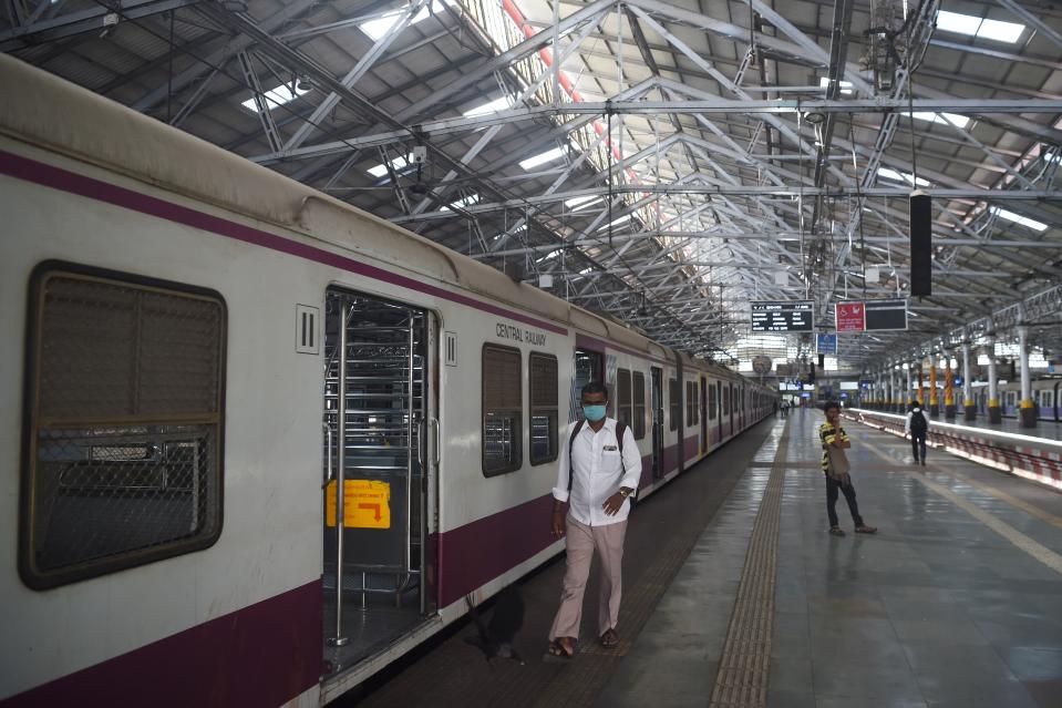 Commuters walk at Chhatrapati Shivaji Maharaj railway terminus during a one-day Janata (civil) curfew imposed amid concerns over the spread of the COVID-19 novel coronavirus, in Mumbai on March 22, 2020. (Photo by Punit PARANJPE / AFP) (Photo by PUNIT PARANJPE/AFP via Getty Images)