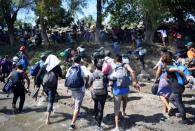 Migrants, part of a caravan travelling to the U.S, cross the Suchiate river from Tecun Uman, in Guatemala, to Ciudad Hidalgo