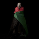 <p>A Palestinian stone thrower — wrapped in a Palestinian flag and masked in a kaffiyeh to conceal his identity — poses for a portrait in the West Bank village of Bilin, near Ramallah on June 13, 2012. (Photo: Oded Balilty/AP) </p>