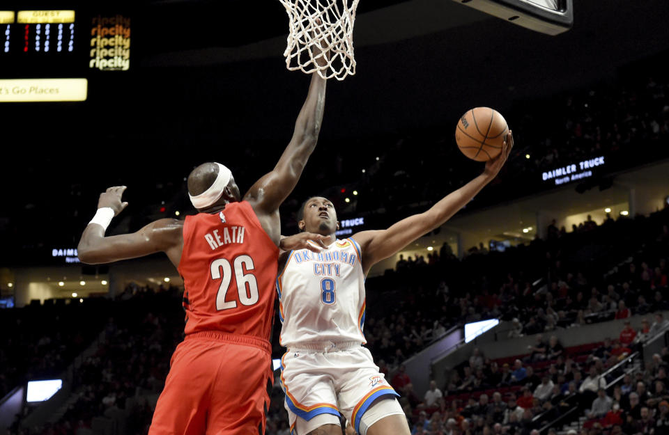 Oklahoma City Thunder forward Jalen Williams, left, drives to the basket against Portland Trail Blazers center Duop Reath, right, during the first half of an NBA basketball game in Portland, Ore., Wednesday, March 6, 2024. (AP Photo/Steve Dykes)