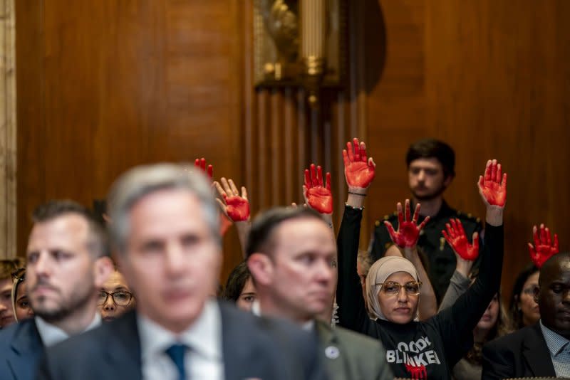 Pro-Palestinian protesters hold painted hands as Secretary of State Antony Blinken speaks during a Senate Appropriations Subcommittee on State, Foreign Operations and Related Programs hearing on proposed fiscal year 2025 budget request at the U.S. Capitol Tuesday. Photo by Bonnie Cash/UPI