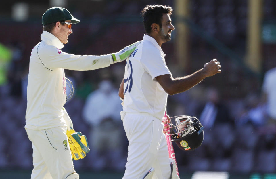 Australian captain Tim Paine, left, congratulates not out batsman India's Ravichandran Ashwin following play on the final day of the third cricket test between India and Australia at the Sydney Cricket Ground, Sydney, Australia, Monday, Jan. 11, 2021. The test ended in a draw and the series is at 1-1 all with one test to play. (AP Photo/Rick Rycroft)