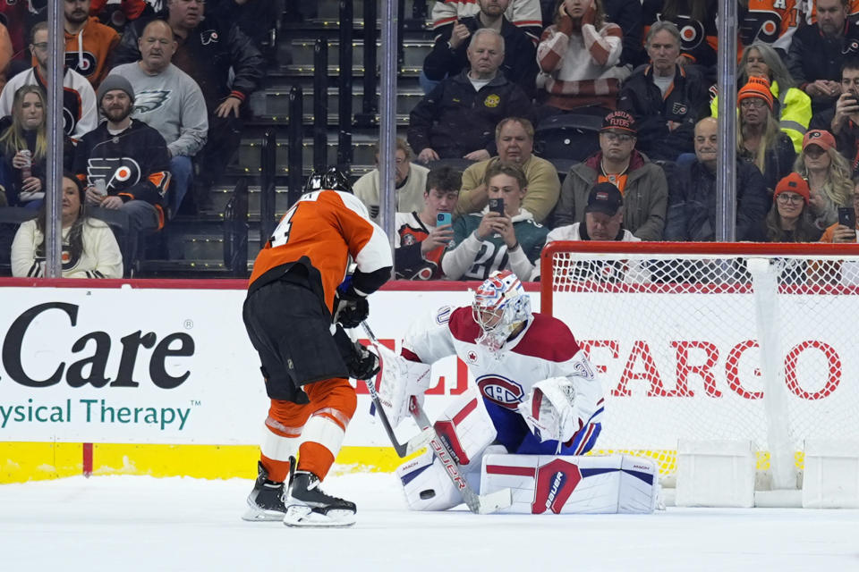 Philadelphia Flyers' Sean Couturier, left, scores against Montreal Canadiens' Cayden Primeau during a shootout in an NHL hockey game, Wednesday, Jan. 10, 2024, in Philadelphia. (AP Photo/Matt Slocum)