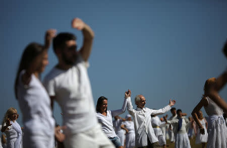 Followers of the Universal White Brotherhood, an esoteric society that combines Christianity and Indian mysticism set up by Bulgarian Peter Deunov in the 1920s, perform a dance-like ritual called "paneurhythmy" in Rila Mountain, Bulgaria, August 19, 2017. REUTERS/Stoyan Nenov