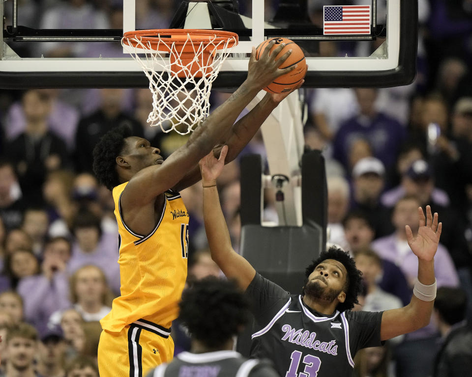 Wichita State center Quincy Ballard (15) shoots under pressure from Kansas State forward Taj Manning (15) during the first half of an NCAA college basketball game Thursday, Dec. 21, 2023, in Kansas City, Mo. (AP Photo/Charlie Riedel)