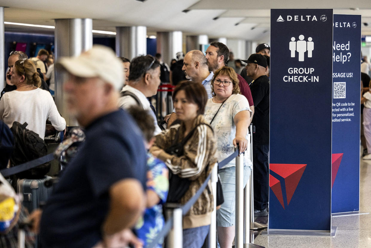 Image: Travelers wait in line at check-in in Terminal 2, Delta Airlines (Etienne Laurent / AFP - Getty Images)