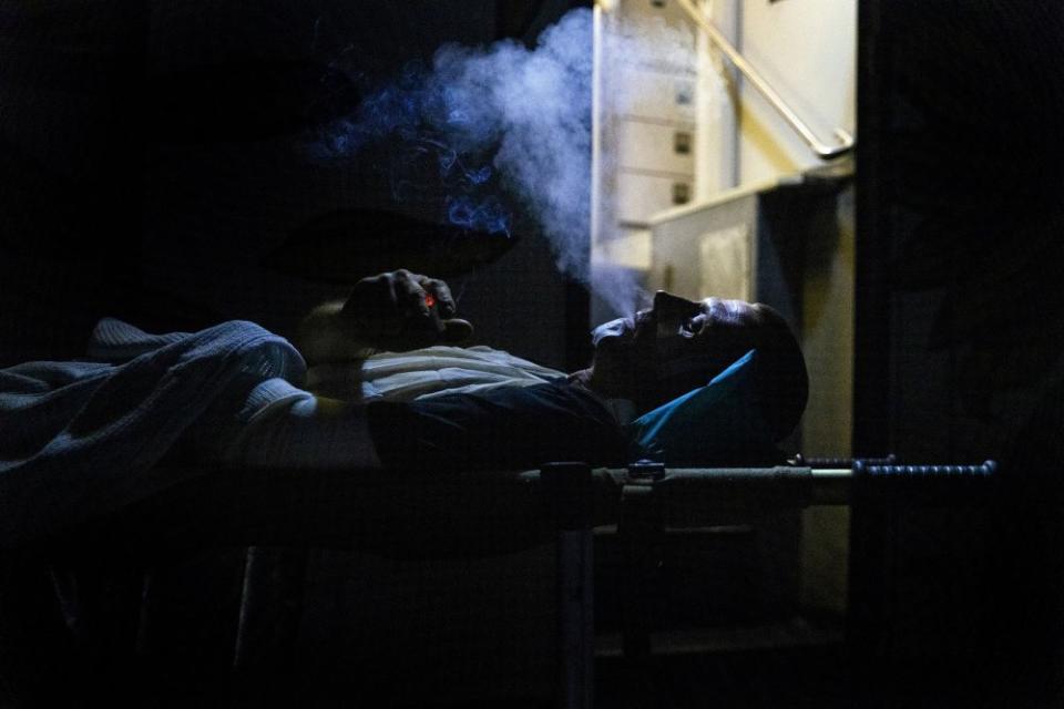 A wounded Ukrainian soldier on a medical stretcher smokes a last cigarette before being loaded onto a mobile hospital bus by medics from the Hospitallers, a Ukrainian volunteer medical battalion providing first aid and evacuation assistance for wounded Ukrainian soldiers, in the Donetsk region of Ukraine on Sept. 12.<span class="copyright">David Guttenfelder—The New York Times/Redux</span>