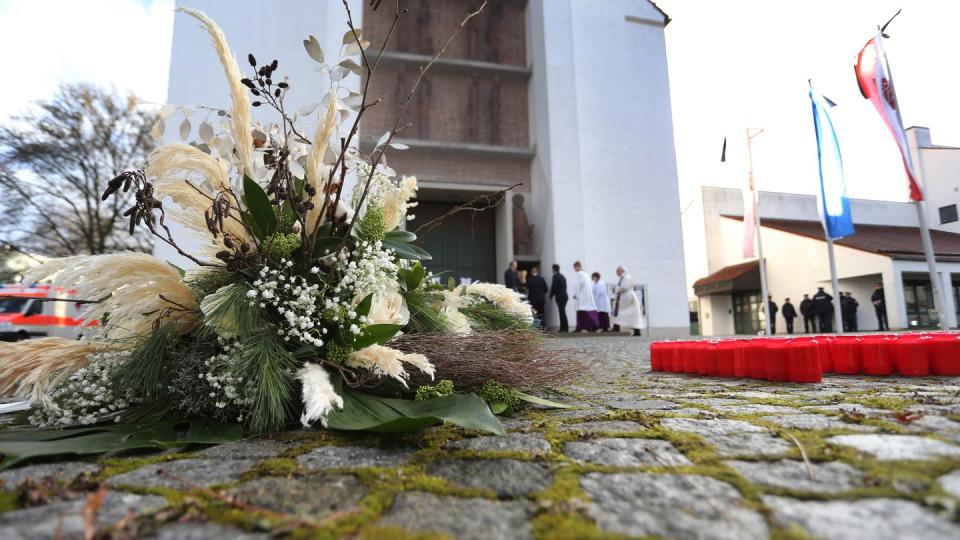 Ein Blumengebinde liegt vor der Kirche in Neusäß bei Augsburg.