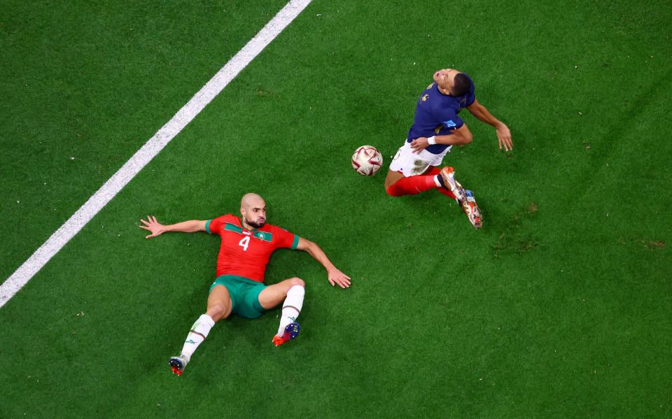 Soccer Football - FIFA World Cup Qatar 2022 - Semi Final - France v Morocco - Al Bayt Stadium, Al Khor, Qatar - December 14, 2022 France's Kylian Mbappe in action with Morocco's Sofyan Amrabat REUTERS/Fabrizio Bensch - REUTERS/Fabrizio Bensch