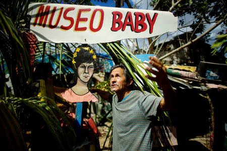 Artist Remigio Hernandez, 64, talks about his self made "Museum of Baby" at his home beside a painting representing his late wife in Moron, Cuba, February 16, 2017. Picture taken February 16, 2017. REUTERS/Alexandre Meneghini