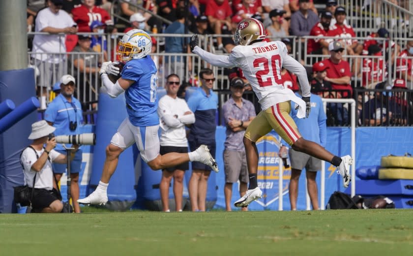 Los Angeles Chargers wide receiver Austin Proehl, left, catches the ball as San Francisco 49ers cornerback Ambry Thomas defends during NFL football practice in Costa Mesa, Calif., Thursday, Aug. 19, 2021. (AP Photo/Damian Dovarganes)