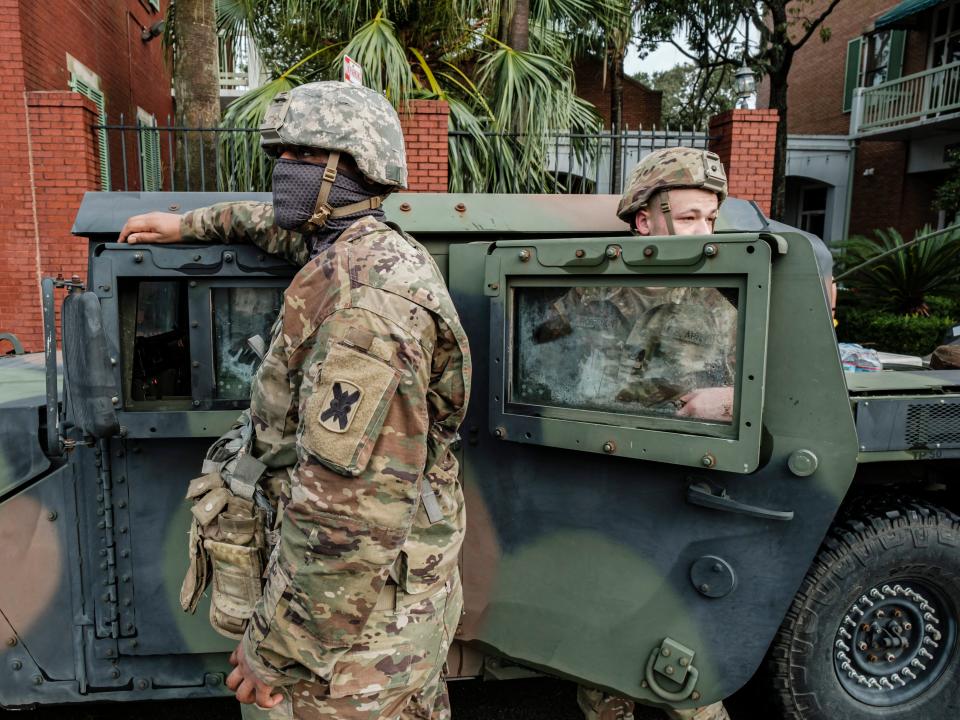Members of the Louisiana National Guard stand outside their vehicles on North Rampart Street to help in Hurricane Ida recovery efforts (EPA)