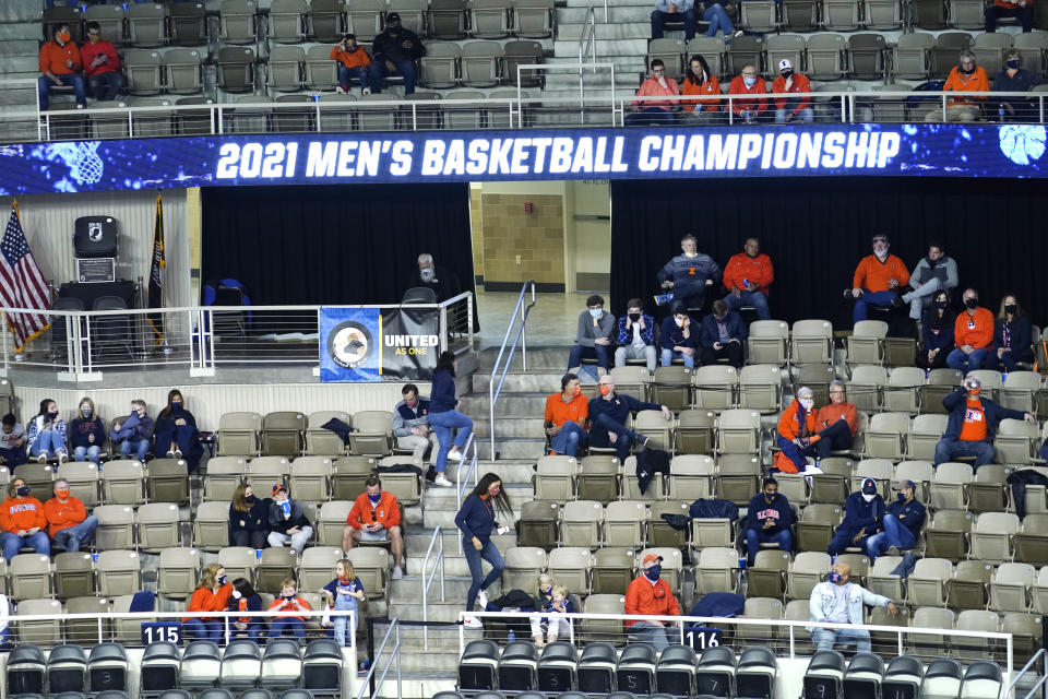 A limited number of fans watch a first round NCAA college basketball tournament game Friday, March 19, 2021, between Drexel and Illinois in Indianapolis. No bands. No cheer squad. No buildings filled with neutral fans suddenly throwing their support behind a plucky double-digit underdog hoping to pull off an upset. This is a decidedly different NCAA tournament experience for players and coaches when they get on the court. (AP Photo/Charles Rex Arbogast)