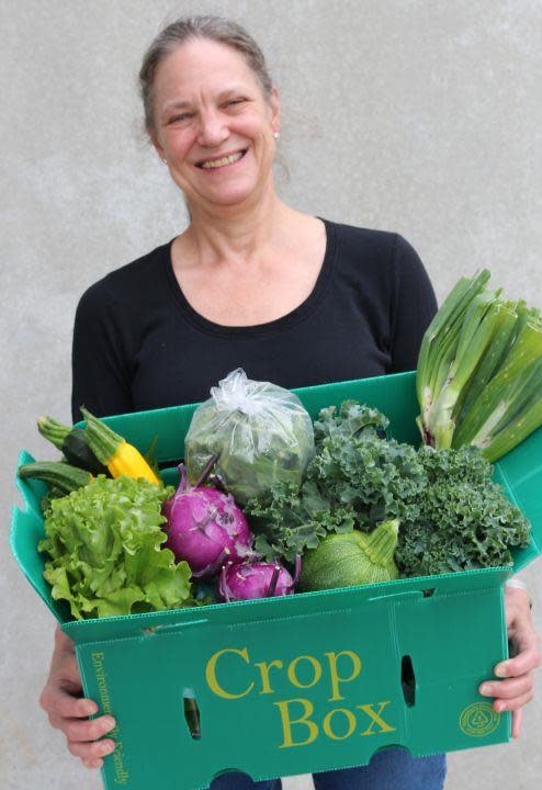 Mary Hipp, Board Chair of Feed & Seed, with fresh, local produce.