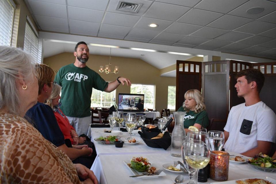 AFP Director of Grassroots Operations, Kyle Miller, standing, talks to the crowd that attended the kickoff for the Ottawa/Sandusky/Erie County Chapter of Americans for Prosperity.