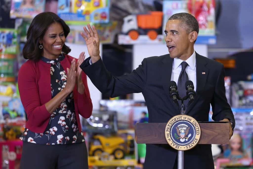 In 2014, Barack Obama and Michelle Obama sort out gifts that will be distributed to less fortunate children in the U.S. (Photo by Chip Somodevilla/Getty Images)