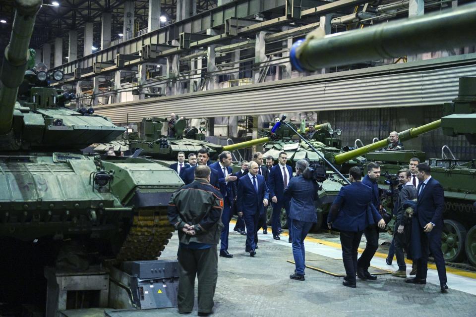 FILE - Russian President Vladimir Putin, center, visits the Uralvagonzavod factory in Nizhny Tagil, Russia, on Feb. 15, 2024. The Russian Prosecutor General's office said Wall Street Journal reporter Evan Gershkovich is accused of “gathering secret information” on orders from the CIA about Uralvagonzavod that produces and repairs tanks and other military equipment. Gershkovich, his employer and the U.S. government deny the charges. (Ramil Sitdikov, Sputnik, Kremlin Pool Photo via AP, File)