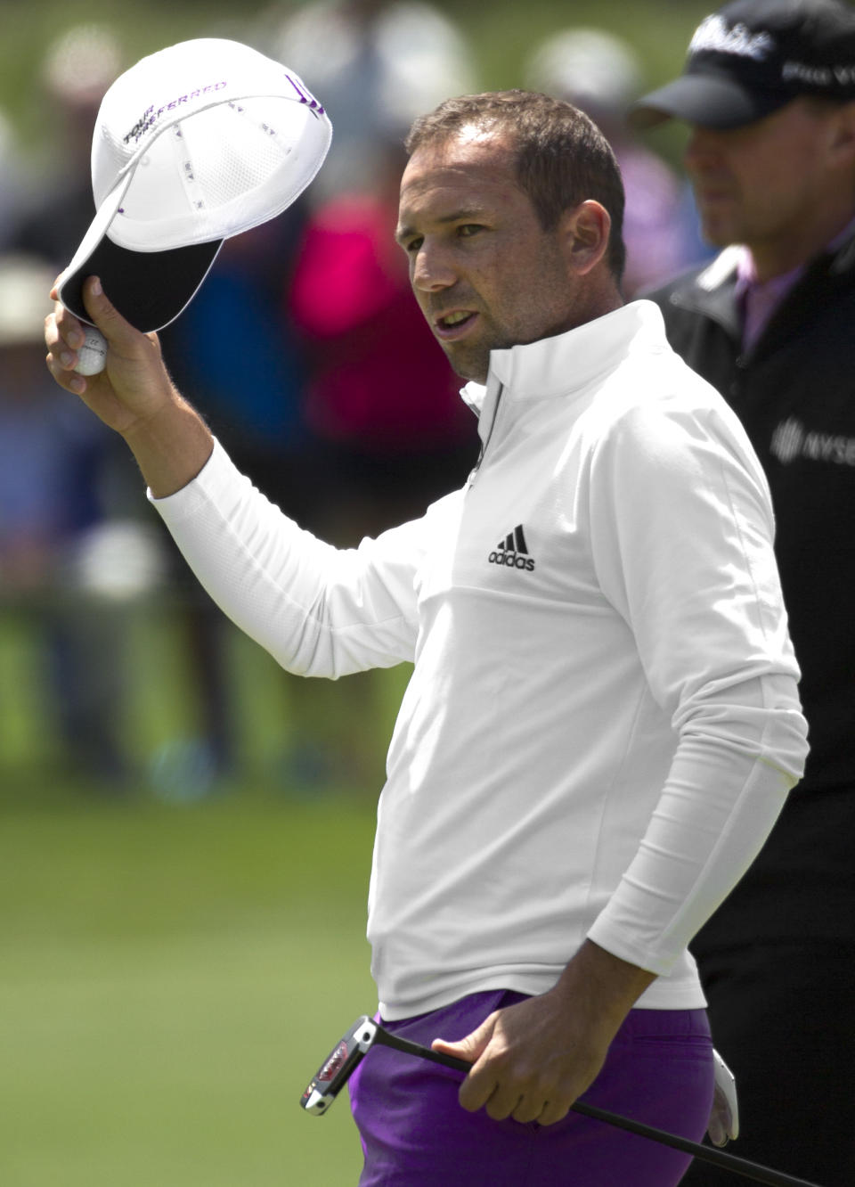 Sergio Garcia tips his hat to the crowd after going seven under for the second round of the Houston Open golf tournament, Friday, April 4, 2014, in Humble, Texas. (AP Photo/Patric Schneider)