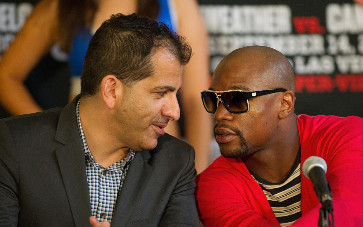 HOUSTON, TX - JULY 01: Stephen Espinoza, Executive Vice President & General Manager, SHOWTIME Sports speaks with Floyd Mayweather during a press conference July 1, 2013 at Union Station at Minute Maid Park in Houston, Texas. Floyd Mayweather and Canelo Alvarez are scheduled to fight September 14 at the MGM Grand Garden Arena in Las Vegas, Nevada.  (Photo by Bob Levey/Getty Images)