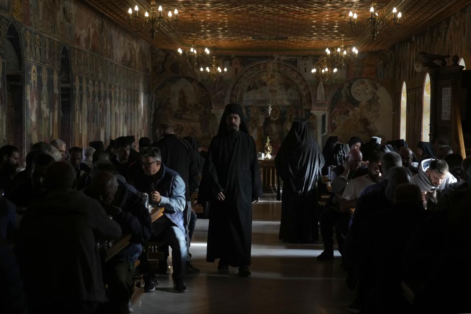 Male visitors eat dinner at Pantokrator Monastery in the Mount Athos, northern Greece, on Thursday, Oct. 13, 2022. The monastic community was first granted self-governance through a decree by Byzantine Emperor Basil II, in 883 AD. Throughout its history, women have been forbidden from entering, a ban that still stands. This rule is called "avaton" and the researchers believe that it concerns every form of disturbance that could affect Mt. Athos. (AP Photo/Thanassis Stavrakis)
