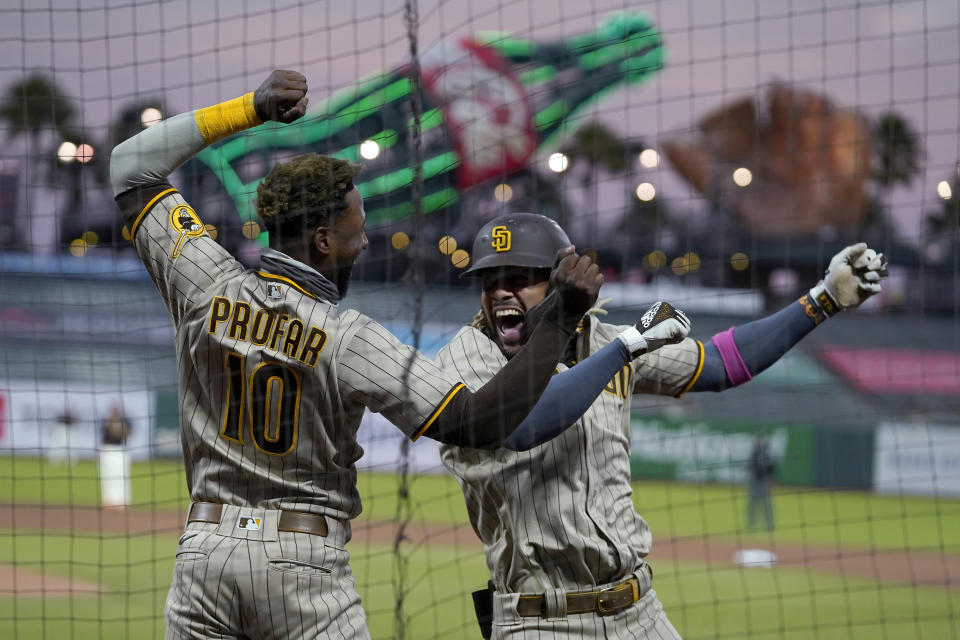 San Diego Padres' Fernando Tatis Jr., right, is congratulated by Jurickson Profar after hitting a solo home run against the San Francisco Giants during the fourth inning of a baseball game in San Francisco, Saturday, Sept. 26, 2020. (AP Photo/Eric Risberg)