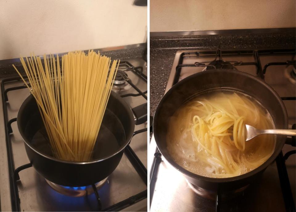 Spaghetti being cooked in boiling water.