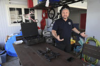 Kainoa Kaku, president of the Hawaii Rifle Association, demonstrates how to conceal carry a handgun that is underneath his shirt, Thursday, June, 23, 2022, in Honolulu. (AP Photo/Marco Garcia)