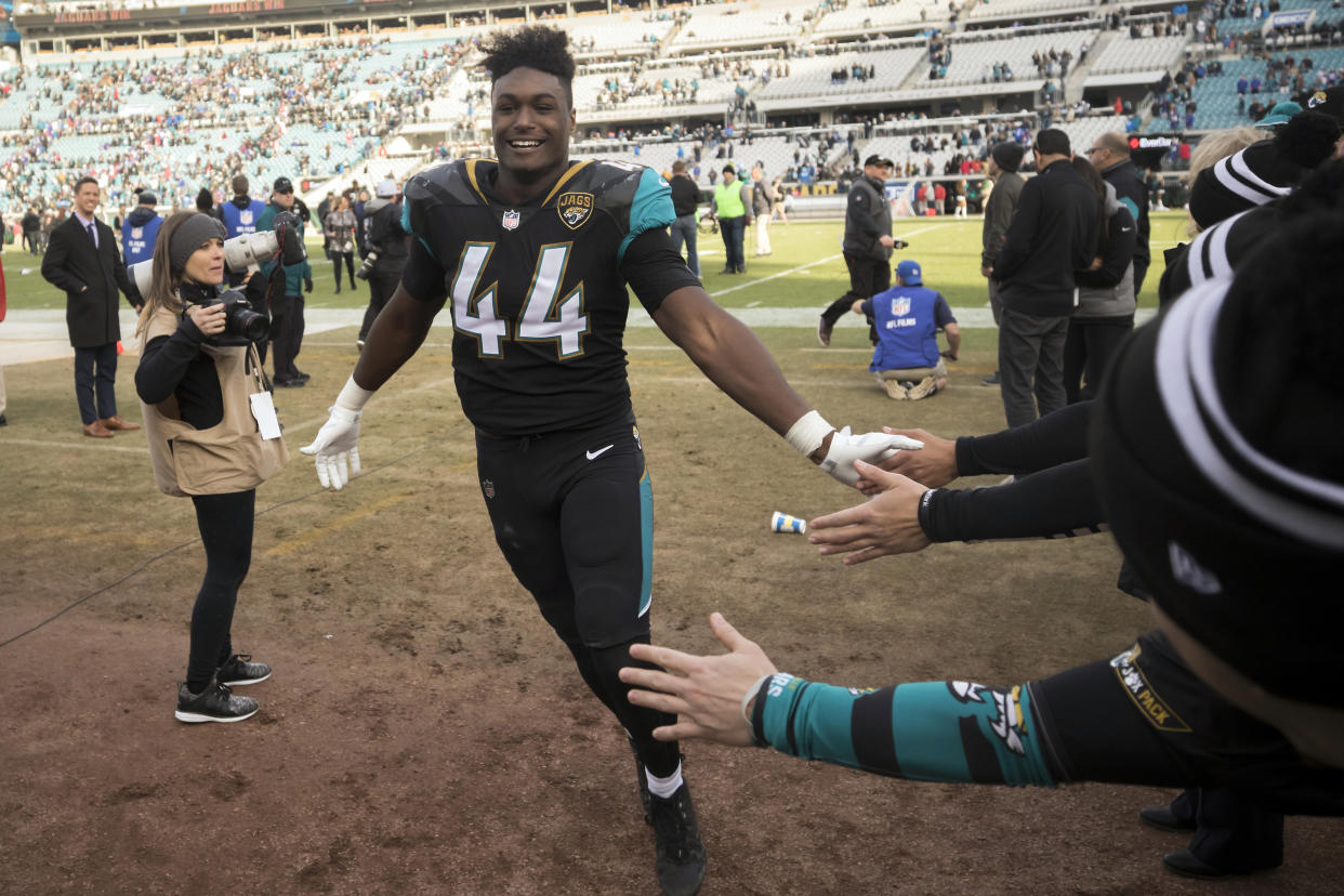 Jacksonville Jaguars outside linebacker Myles Jack (44) celebrate in the tunnel with fans at the end of an NFL wild-card playoff football game against the Buffalo Bills, Sunday, Jan. 7, 2018, in Jacksonville, Fla. Jaguars beat the Bills 10-3. (AP Photo/Stephen B. Morton)