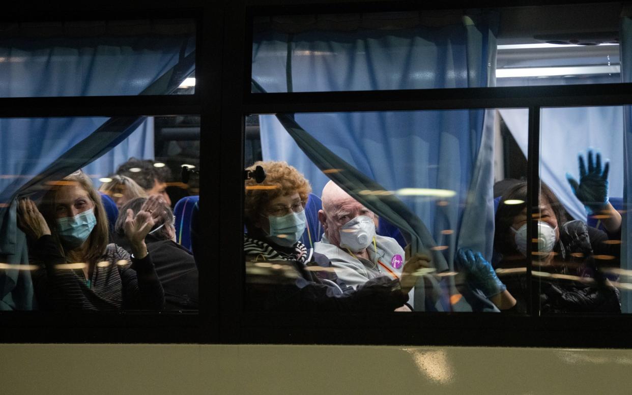 American citizens wave from a bus as they leave the quarantined Diamond Princess cruise ship at Daikoku Pier to be repatriated to the United States - Carl Court/Getty Images