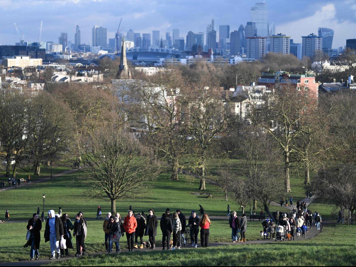 <p>People take daily excercise at Primrose Hill, north London </p> (AFP via Getty)