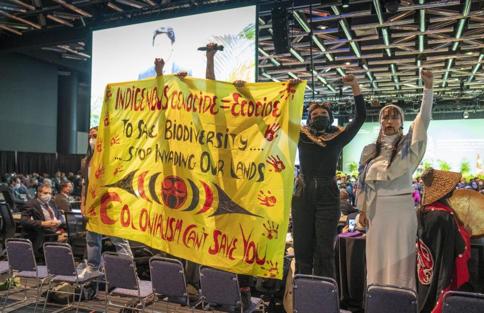 Protesters urge governments to stop invading Indigenous land in the process of biodiversity conservation during the opening ceremony of the COP15 UN conference on biodiversity in Montréal. THE CANADIAN PRESS/Paul Chiasson