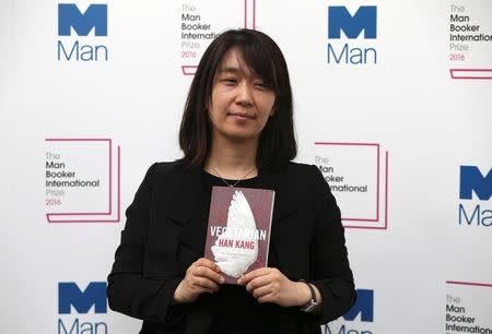 South Korean author Han Kang poses with her novel "The Vegetarian", which is nominated for the Man Booker International Prize, during a media event in London, Britain May 15, 2016. REUTERS/Neil Hall/File Photo