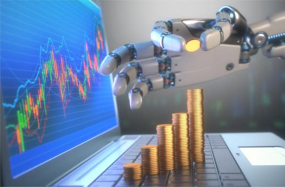 A robot hand stacking coins in front of a financial chart.