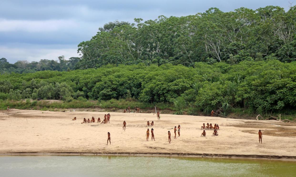 <span>Members of the Mashco Piro Indigenous community gather on the banks of the Las Piedras river in the Madre de Dios province of Peru on 27 June 2024.</span><span>Photograph: Survival International</span>