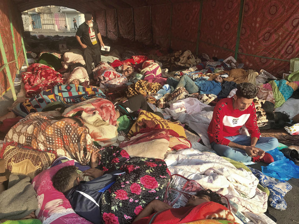 Anti-government protesters rest during sit-in at Tahrir Square in Baghdad, Iraq, Saturday, Oct. 26, 2019. Iraqi protesters converged on a central square in the capital Baghdad on Saturday as security forces erected blast walls to prevent them from reaching a heavily fortified government area after a day of violence that killed scores. (AP Photo/Ali Abdul Hassan)