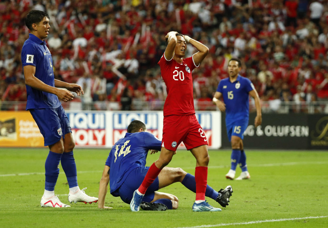 Singapore's Shawal Anuar holds his head after missing an opportunity against Thailand in their 2026 World Cup qualifier at National Stadium. 