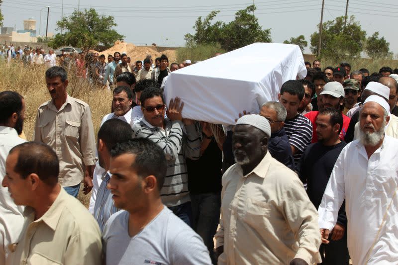 FILE PHOTO: Pallbearers carry the coffin of Megrahi during his burial at a cemetery in Janzour