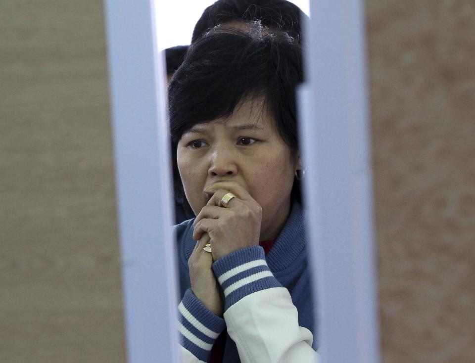 A relative of a passenger aboard the sunken ferry Sewol in the water off the southern coast watches the official list of the dead victims at a port in Jindo, South Korea, Monday, April 21, 2014. Divers continued the grim work of recovering bodies from inside the sunken South Korean ferry Monday, as a newly released transcript showed the ship was crippled by confusion and indecision well after it began listing. The transcript suggests that the chaos may have added to a death toll that could eventually exceed 300. (AP Photo/Ahn Young-joon)