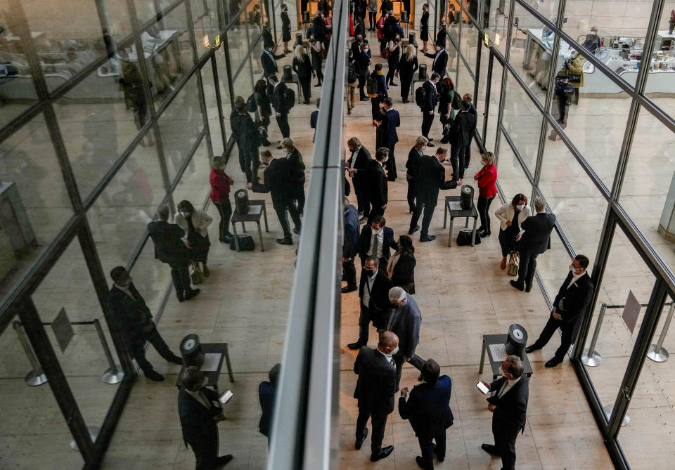 Lawmakers cast their votes during a parliament Bundestag session about new measures to battle the coronavirus pandemic at the Reichstag building in Berlin, Germany, Thursday, Nov. 18, 2021. (AP Photo/Markus Schreiber)