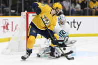 Seattle Kraken goaltender Philipp Grubauer (31) stops a shot as Nashville Predators center Mark Jankowski (17) looks for the rebound during the second period of an NHL hockey game Saturday, March 25, 2023, in Nashville, Tenn. (AP Photo/Mark Zaleski)