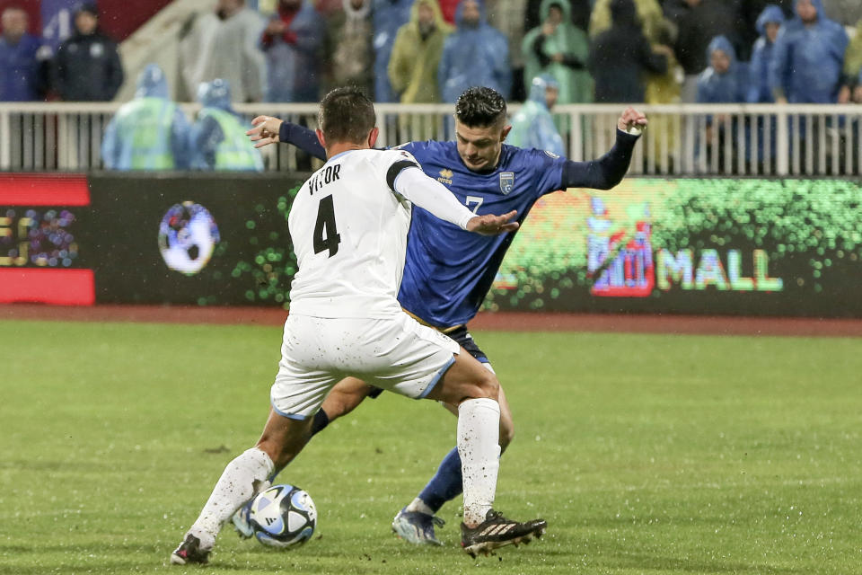 Kosovo's Milot Rashica, right, Israel's Miguel Vitor, left, challenge for the ball during the Euro 2024 group I qualifying soccer match between Kosovo and Israel at the Fadil Vokrri stadium in Pristina, Kosovo, Sunday, Nov. 12, 2023. (AP Photo/Visar Kryeziu)